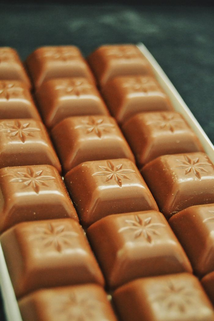 About Close-up of milk chocolate bars with star design. Tempting sweet treats.