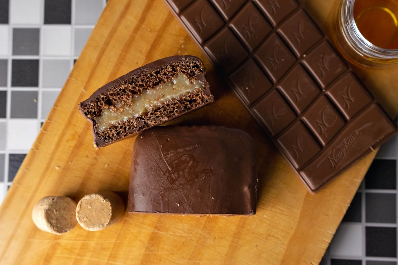 Services Top view of chocolate bars with filling on a wooden board, perfect for dessert lovers.